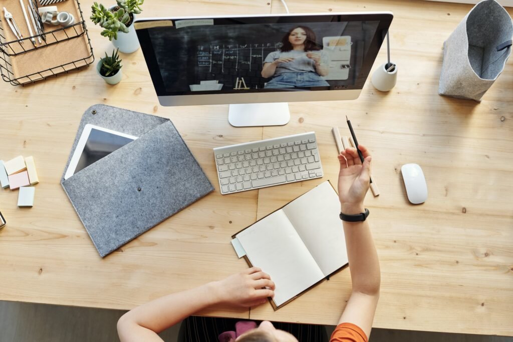 A student engages in a certified online course, displayed on a desktop screen, indicating the progressive direction of education in a digital era.