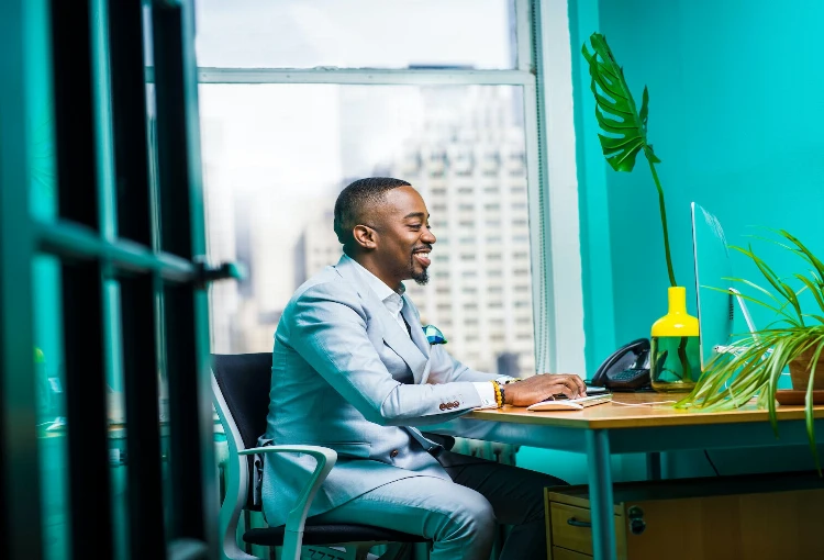 man sitting in front of keyboard reading about the 10 skill requirements in 2024 job market 