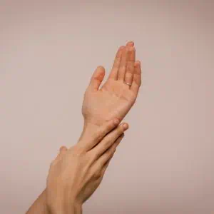 Close-up of two hands performing a high five, symbolising teamwork and collaboration.