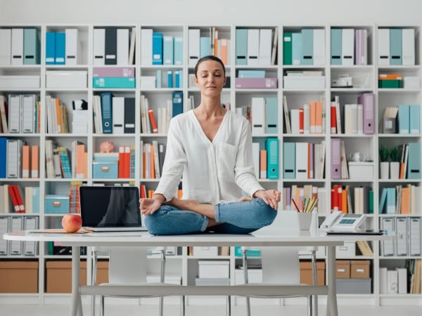 woman-practicing-meditation-on-a-desk