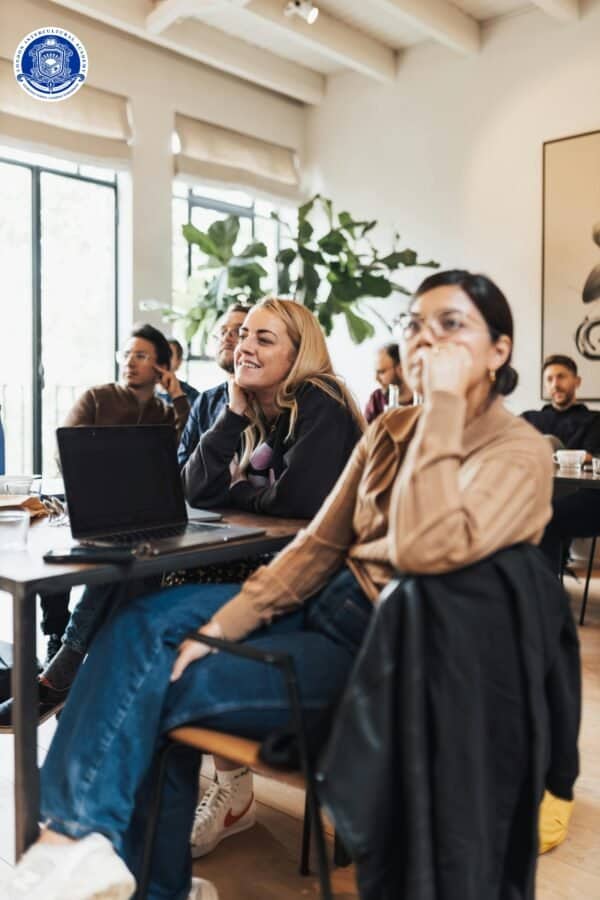 Engaged participants attending a diversity and inclusion training workshop in a bright, modern class.