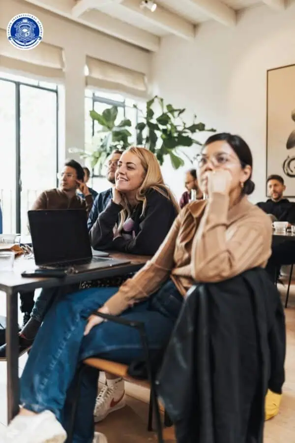Engaged participants attending a diversity and inclusion training workshop in a bright, modern class.