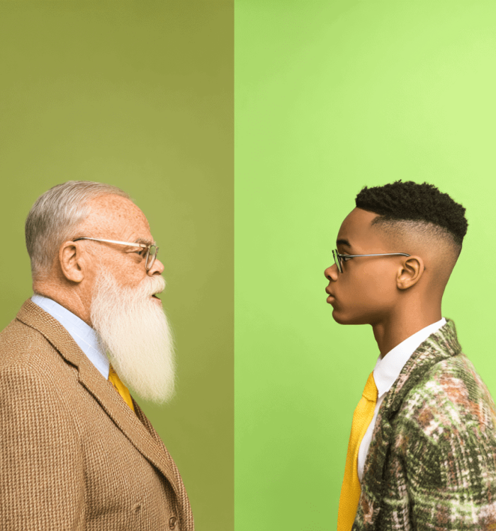 Elderly man and young man facing each other, focused on conversation, emphasizing employee training and workforce development programs.